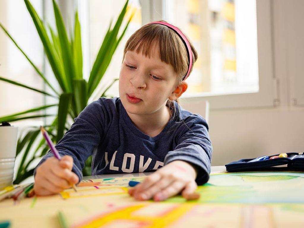 child drawing indoors