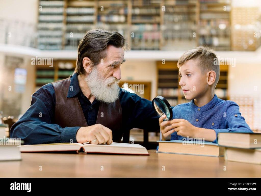 elderly man boy reading